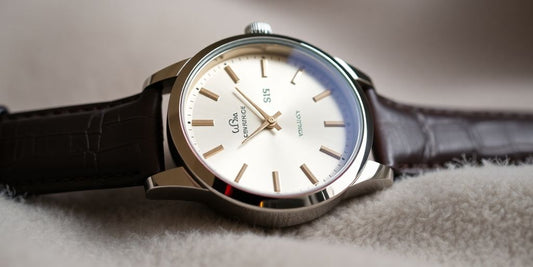 Close-up of an elegant luxury watch on a surface.